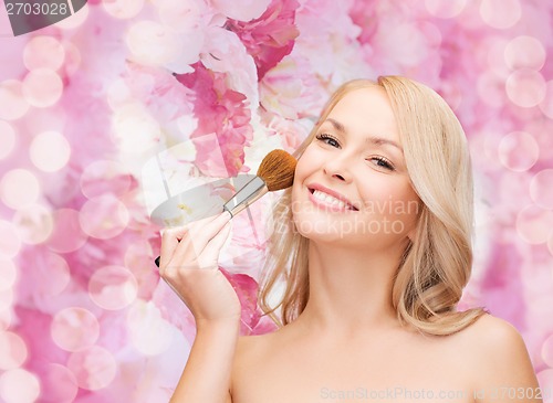 Image of beautiful woman with closed eyes and makeup brush