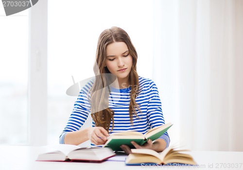 Image of concentrated student girl with books