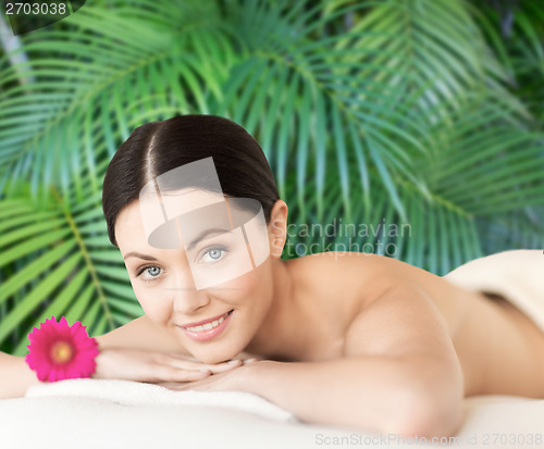 Image of smiling woman lying on the massage desk