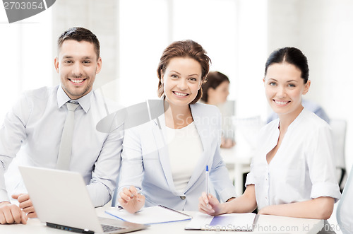 Image of business team discussing something in office