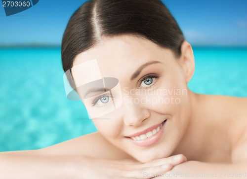 Image of smiling woman on the beach