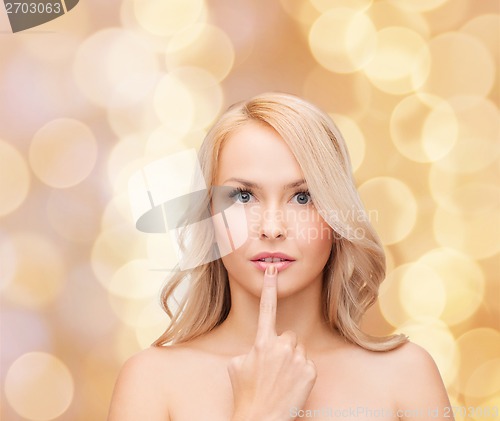 Image of woman touching her lips