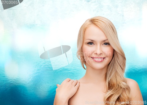 Image of face and shoulders of happy woman with long hair