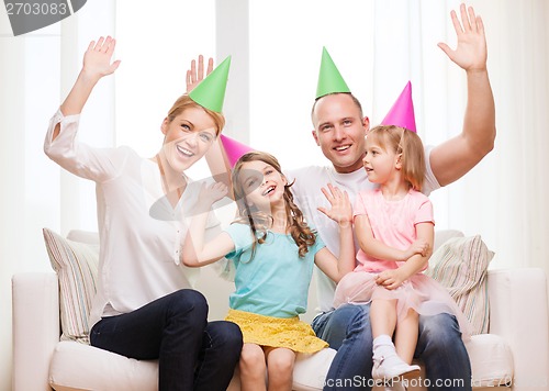 Image of happy family with two kids in hats celebrating