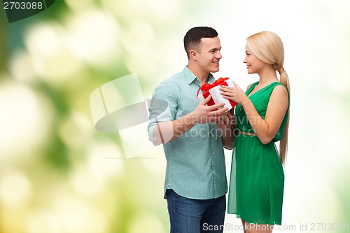 Image of smiling couple with gift box