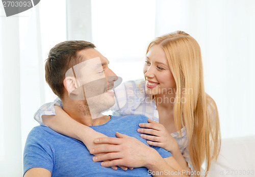 Image of smiling happy couple at home