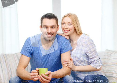 Image of smiling man with cup of tea or coffee with wife