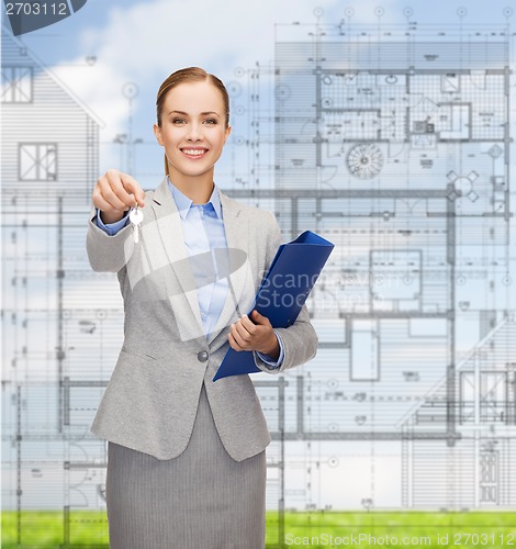 Image of smiling businesswoman with folder and keys