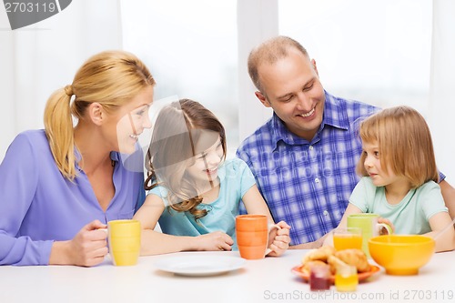 Image of happy family with two kids with having breakfast