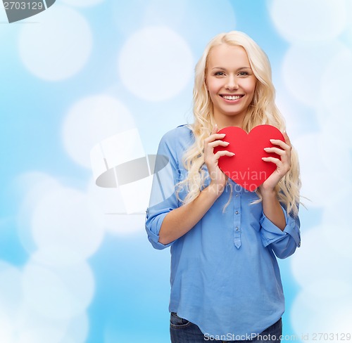 Image of smiling woman with red heart