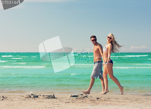 Image of couple walking on the beach