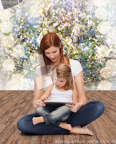 Image of happy mother with little girl and tablet pc
