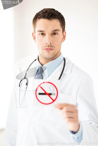 Image of male doctor holding no smoking sign