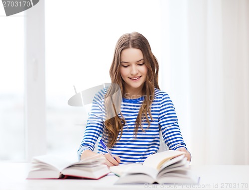 Image of happy smiling student girl with books