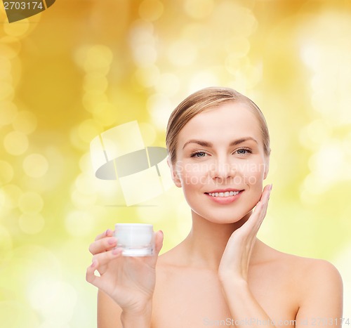 Image of woman applying cream on her skin