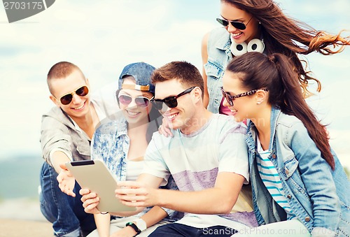 Image of group of teenagers looking at tablet pc