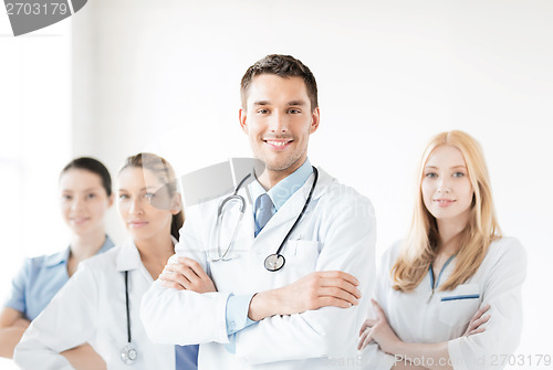 Image of male doctor in front of medical group