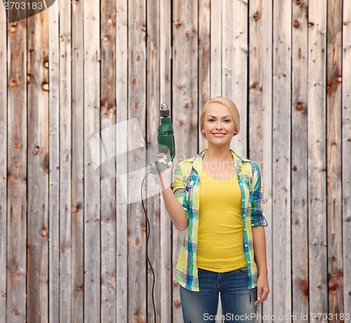 Image of smiling woman with drill machine