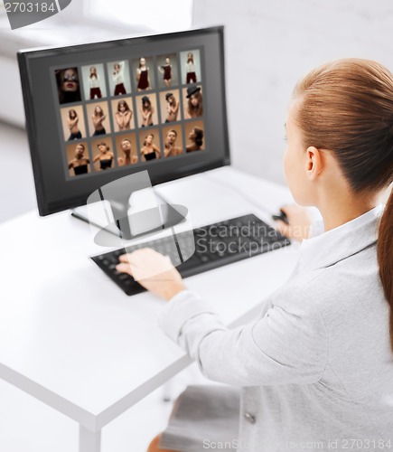 Image of editor choosing pictures from computer monitor