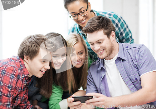 Image of students looking at smartphone at school