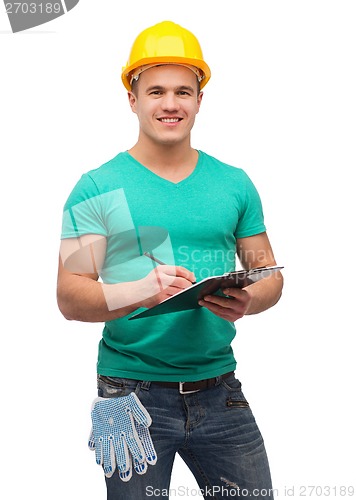 Image of smiling man in helmet with clipboard