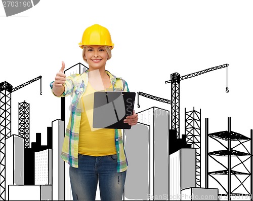 Image of smiling woman in helmet with clipboard