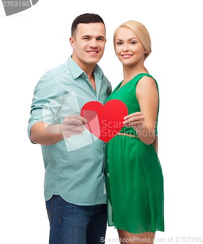 Image of smiling couple holding big red heart