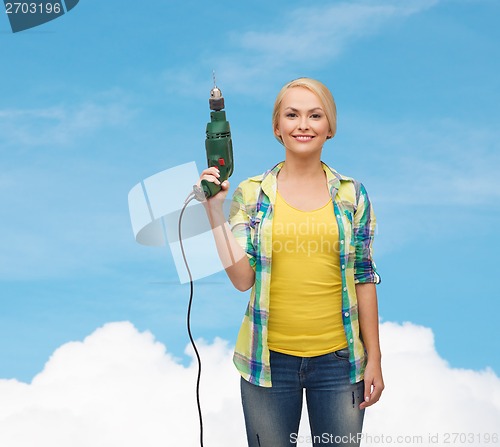 Image of smiling woman with drill machine