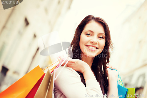 Image of woman with shopping bags in city