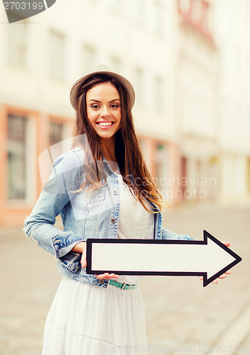 Image of girl showing direction with arrow in the city