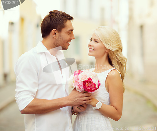 Image of couple with flowers in the city