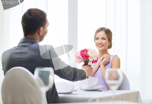 Image of smiling woman recieving bouquet of flowers