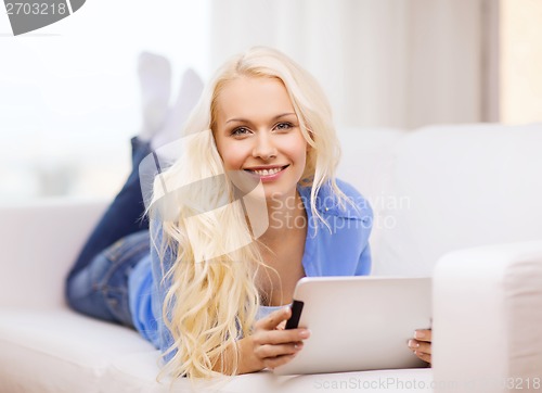 Image of smiling woman with tablet pc computer at home