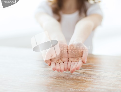 Image of close up of little girl showing empty cupped hands