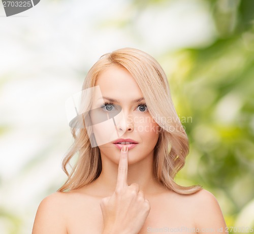 Image of woman touching her lips