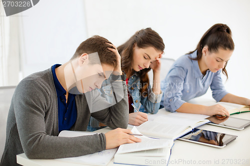 Image of students with notebooks and tablet pc at school