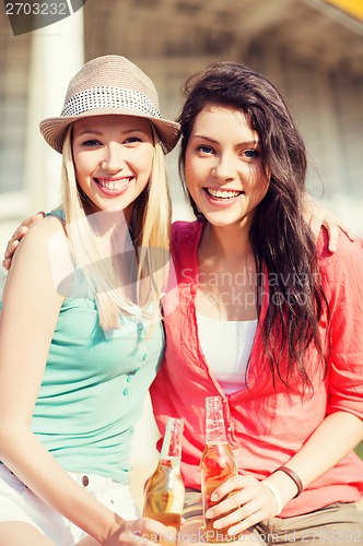 Image of girls with drinks on the beach