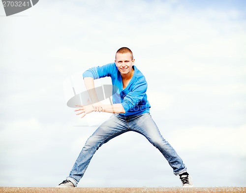 Image of handsome boy making dance move