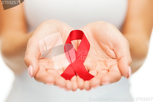 Image of hands holding red AIDS awareness ribbon