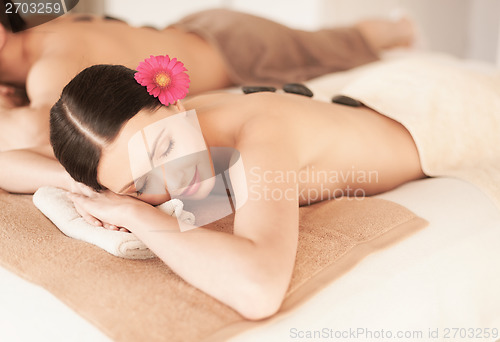 Image of couple in spa with hot stones