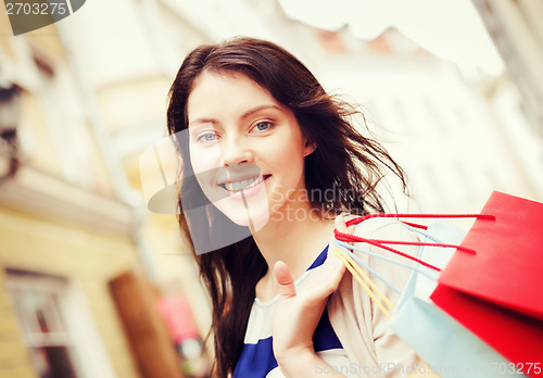 Image of woman with shopping bags in city