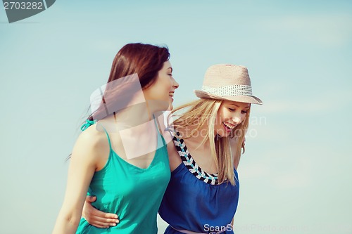 Image of girls walking on the beach