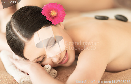 Image of woman in spa with hot stones