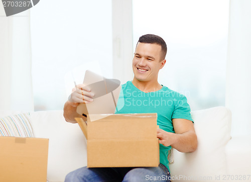 Image of opening cardboard box and taking out tablet pc