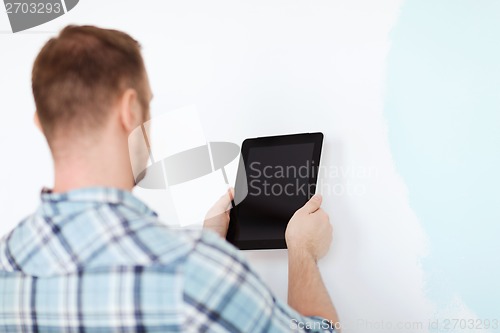 Image of close up of male with tablet pc with blank screen