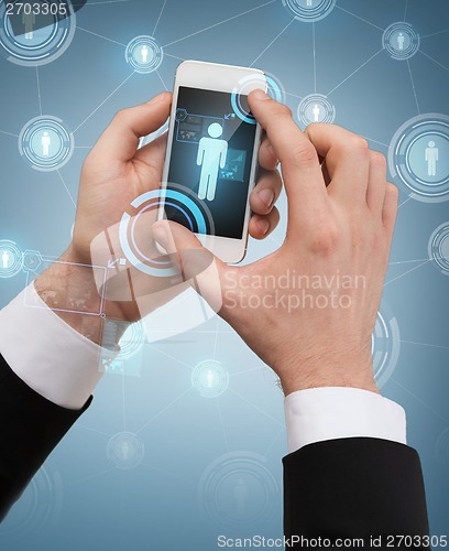 Image of businessman touching screen of smartphone