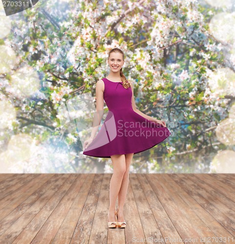 Image of young woman in purple dress and high heels