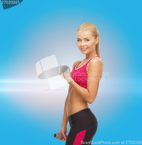 Image of young sporty woman with light dumbbells