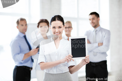 Image of businesswoman with tablet pc in office