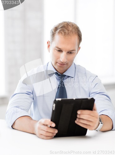 Image of businessman with tablet pc in office